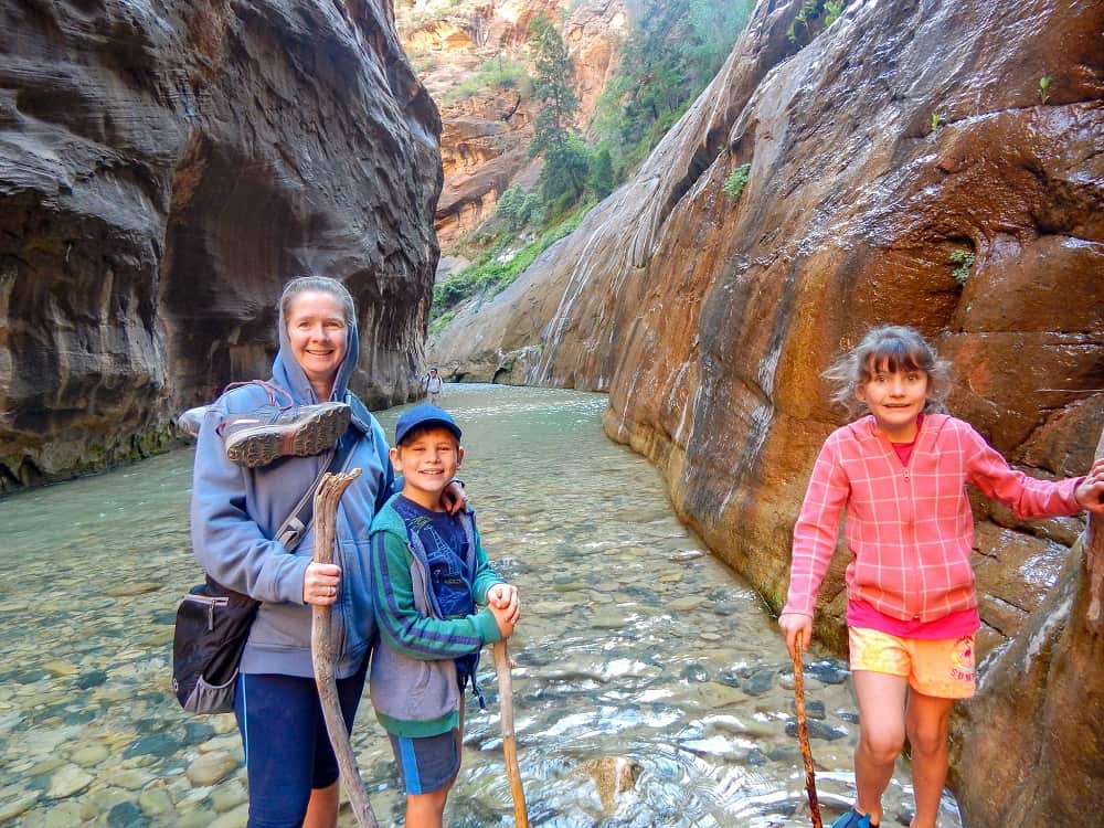 rovingfoleys at the narrows zion national park standing in the river