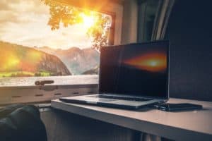Laptop Computer on a Camper Table with Scenic View.