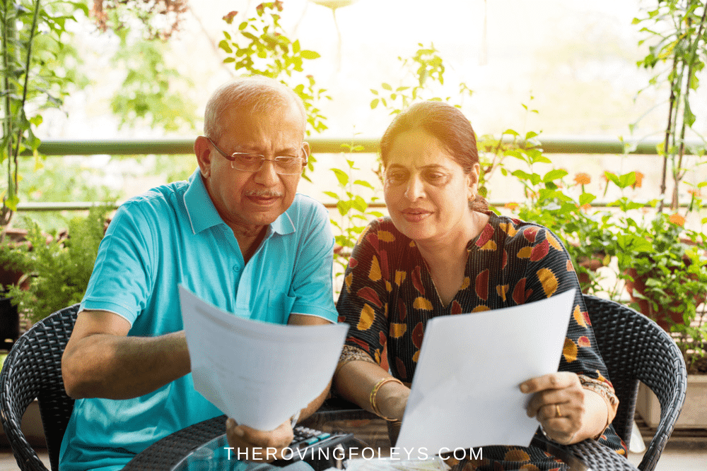Indian couple in teal looking at papers