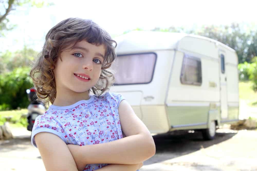 young girl with rv in the background