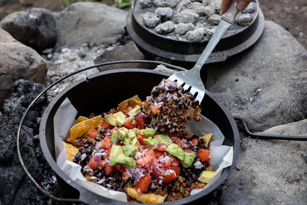 small dutch oven with liner and nachos and fork