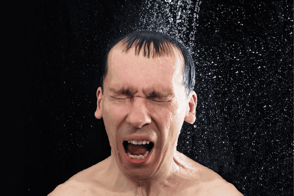 man cringing in cold rv shower
