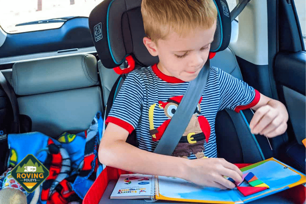 boy reading a book in car