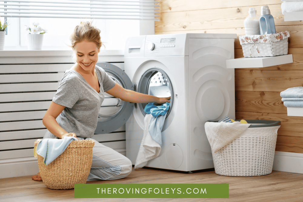 woman putting laundry onto machine