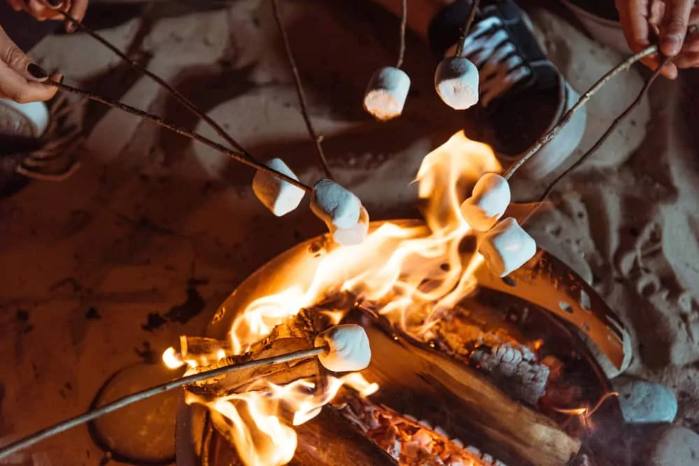 Marshmallows cooking over a portable fire pit