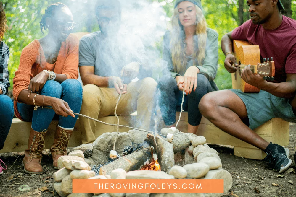 people around a smoky campfire